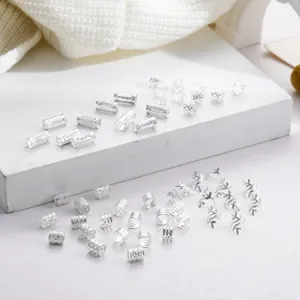 Detailed macro shot of 50 pieces silver hollow dreadlock cuffs and leaf hair rings