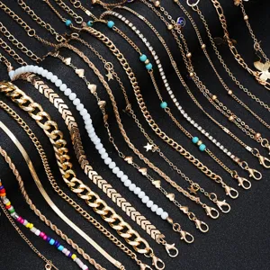 Detailed view of 22-piece gold anklet set featuring various chain styles and charms