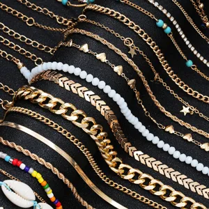 Close-up detail of a 22pcs gold anklet set featuring bohemian shells, beads, and charms