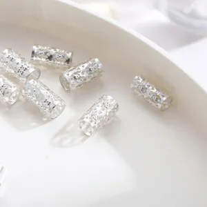 Detailed macro view of silver hollow-out filigree rings for dreadlocks hair jewelry