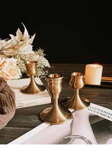 Elegant vintage brass-style aluminum candle holders shown in a classic home decor setting