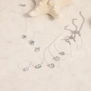 Close-up detail of transparent fishing line zircon necklaces and rings with silver clasps.