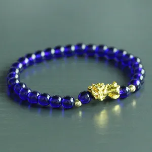 Blue crystal bead bracelet with gold Pi Xiu charm, stylish lucky jewelry for men and women.