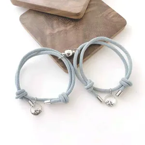 Vue détaillée des bracelets tressés magnétiques de couple avec des pendentifs en métal.