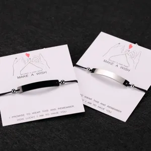 Couple matching wish bracelets with curved stainless steel bar on card, black and silver.