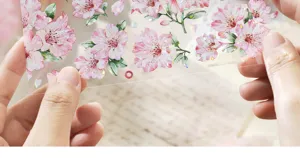 Detailed view of pink floral PET tape with shell light holographic finish for scrapbooking