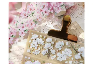 Detailed look at PET stickers with cherry blossom and white magnolia floral patterns.