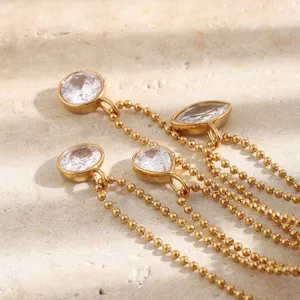 Close-up of multi-strand gold bead necklace with various shaped zircon pendants
