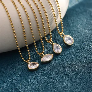 Macro view of 18K gold plated stainless steel necklaces with sparkling cubic zircon pendants