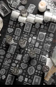 Detailed view of vintage white lace PET tape with rose and butterfly patterns for journaling