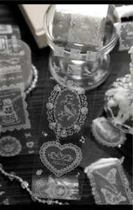 Macro view showing the intricate white lace patterns on transparent PET decorative tape