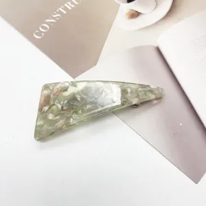 Detailed view of triangular resin hair clip with elegant light green marble pattern