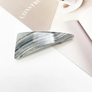 Close-up of grey marble pattern resin hair clip with geometric triangular design