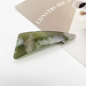 Close-up of olive green marble pattern resin hair clip with elegant swirl texture
