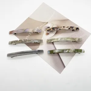Minimalist resin rectangular spring hair clips in various marble and tortoiseshell patterns.