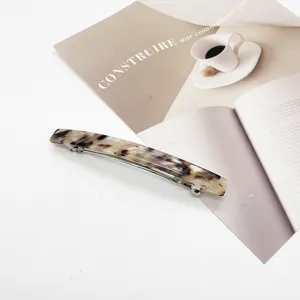Close-up of elegant tortoiseshell resin hair clip with silver spring mechanism