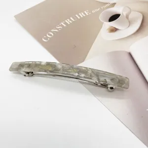 Close-up of elegant marble pattern resin rectangular hair barrette with spring clip