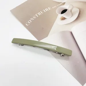 Detail view of a minimalist sage green resin rectangular barrette hair clip.