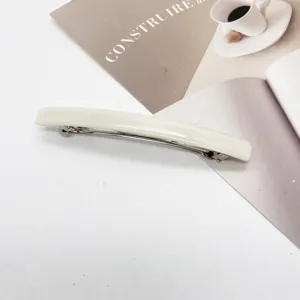 Close-up of minimalist cream white resin rectangular spring barrette hair clip design