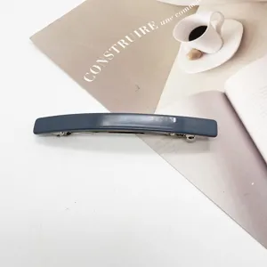 Close-up of a minimalist gray-blue resin rectangular barrette on an aesthetic background.