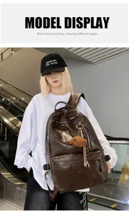 Close-up detail of retro soft leather large capacity backpack worn by model in a white shirt