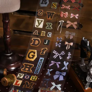 Borduurstijl alfabet en strikken decoratieve stickers voor journaling en scrapbooking