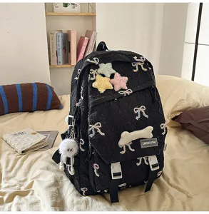 Mochila escolar negra kawaii con bordado de lazos y estrellas de peluche en dormitorio acogedor