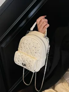 Elegant cream quilted mini backpack featuring rhinestone studs and a metal chain strap