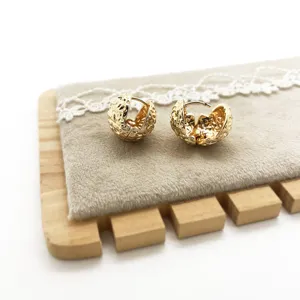 Detail showing the intricate hammered texture of these golden geometric hoop earrings