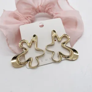 Detailed view of oversized gold geometric ocean series alloy earrings on white card
