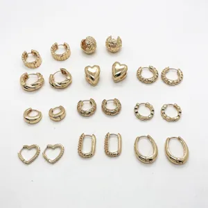 Set of multiple minimalist gold-plated geometric alloy hoop and stud earrings.
