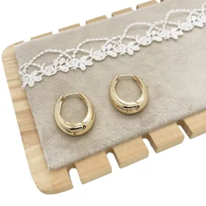 Premium minimalist geometric gold alloy hoop earrings on a soft velvet display board