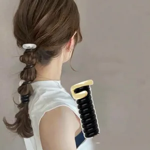 Side view showing a metallic spiral hair tie creating a stylish bubble braid ponytail