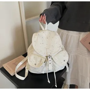 Minimalist white women's backpack featuring silver star patterns and a drawstring flap