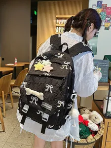 Mochila escolar negra linda para niñas con bordado de lazos y estrellas de peluche