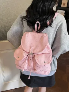 Pink drawstring flap backpack for women with silver star patterns shown from a back view
