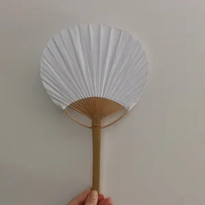 Detailed shot of a white hand fan with natural bamboo handle, perfect for DIY painting.