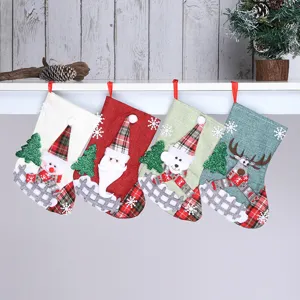 Christmas linen stocking detail shot showing assorted holiday designs with festive elements.