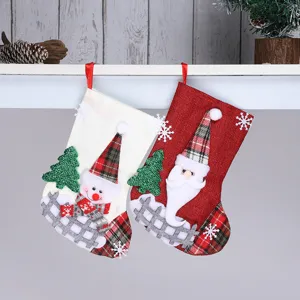 Christmas burlap stocking detail shot featuring cute snowman and Santa Claus for holiday decor.
