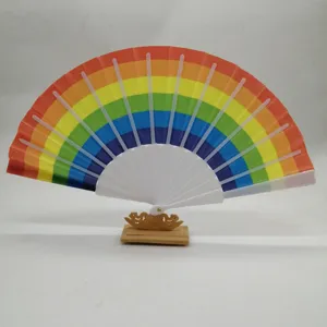 Detailed view of the 23cm rainbow folding fan featuring white plastic ribs and wooden stand.