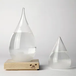 Creative water drop storm glass weather predictor with wooden base for home decor.