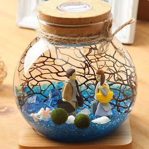 Glass moss terrarium jar with LED cork lid, cute couple figurines and miniature landscape.