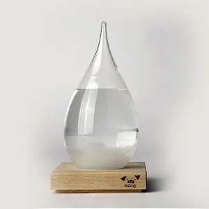 Detailed view of the teardrop glass storm glass weather predictor on a wood base.