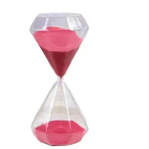Diamond shaped hourglass timer with pink sand, clear glass decorative ornament for home desktop decor.