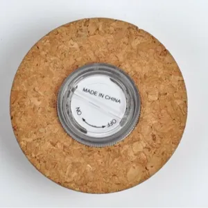 Round cork lid with integrated LED light switch for glass terrarium jar, main display view.