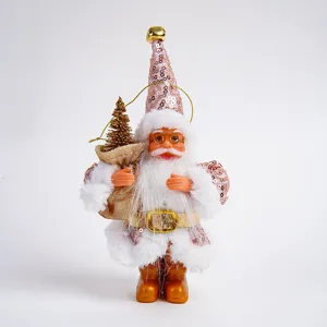Close-up details of the Christmas Santa Claus plush figurine holding a mini tree ornament.
