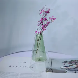 Double layer glass vase detail showing the clear and green cone shaped minimalist design.