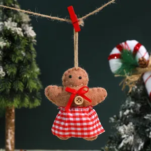 Detailed shot of cute felt gingerbread man hanging ornament with red checkered skirt.