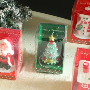 Detailed close-up of the festive Christmas candle gift set, featuring painted tree and snowman.
