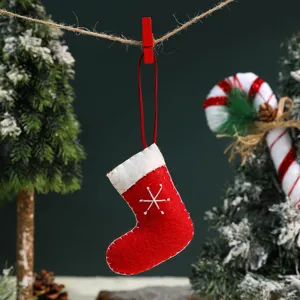 Mini red felt Christmas stocking hanging ornament close-up with white snowflake detail.